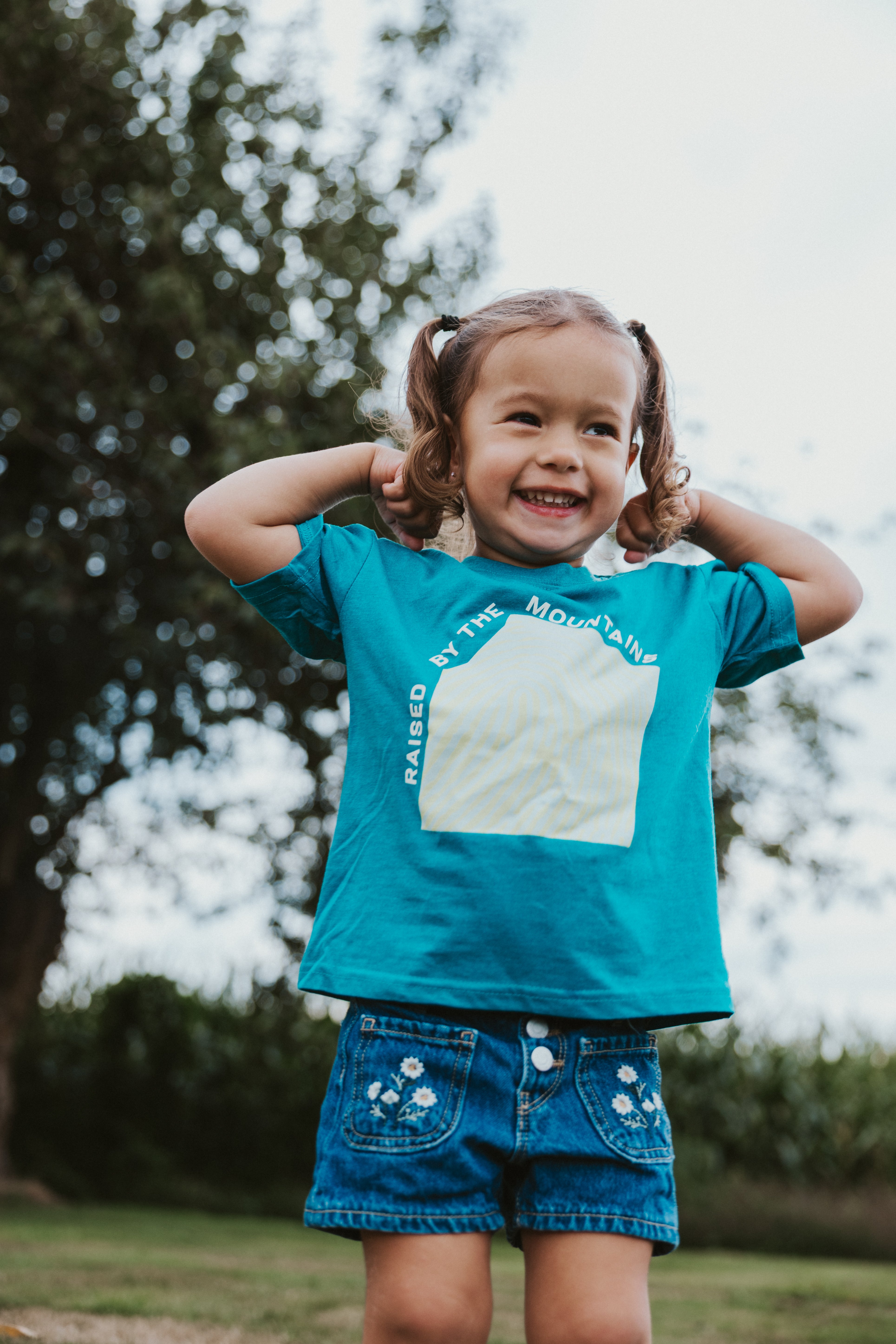 Raised by the Mountains Kids Tee