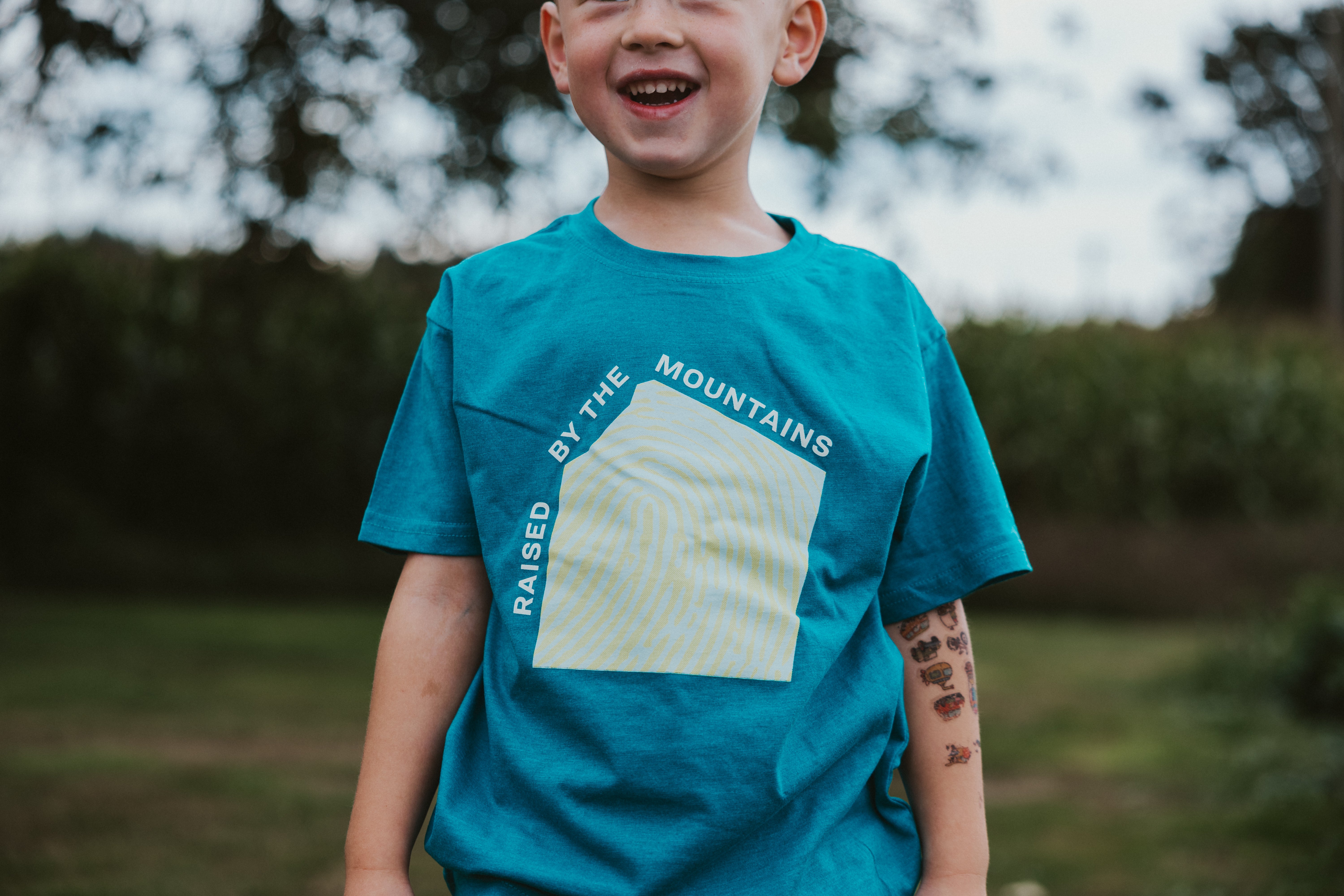 Raised by the Mountains Kids Tee
