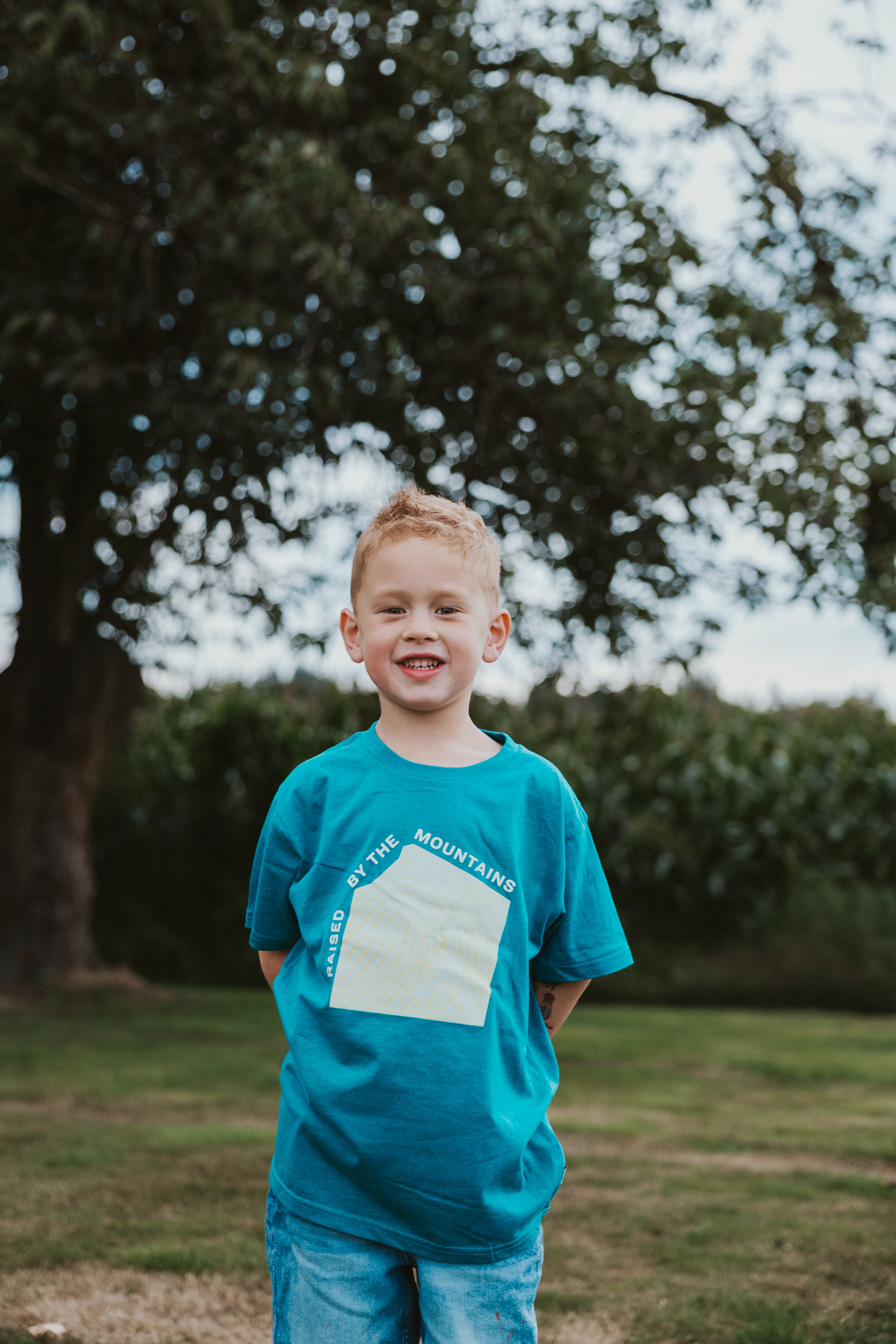 Raised by the Mountains Kids Tee