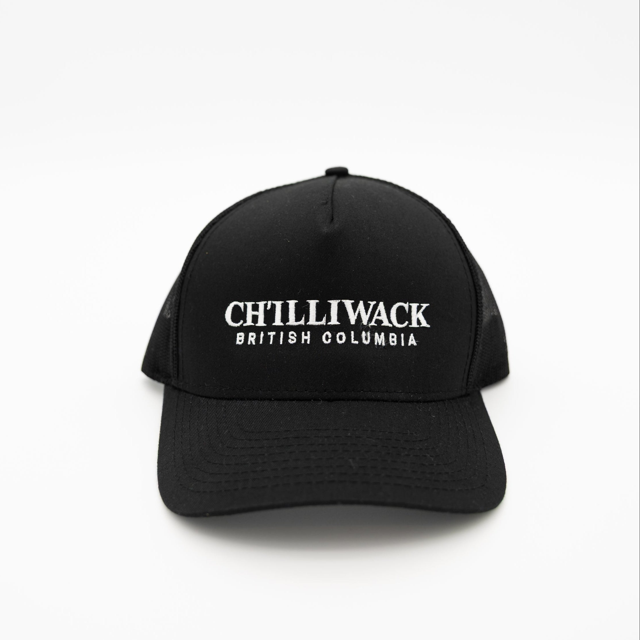 A black trucker-style baseball cap with white embroidered text reading 'CHILLIWACK BRITISH COLUMBIA' on the front, shown against a plain white background.