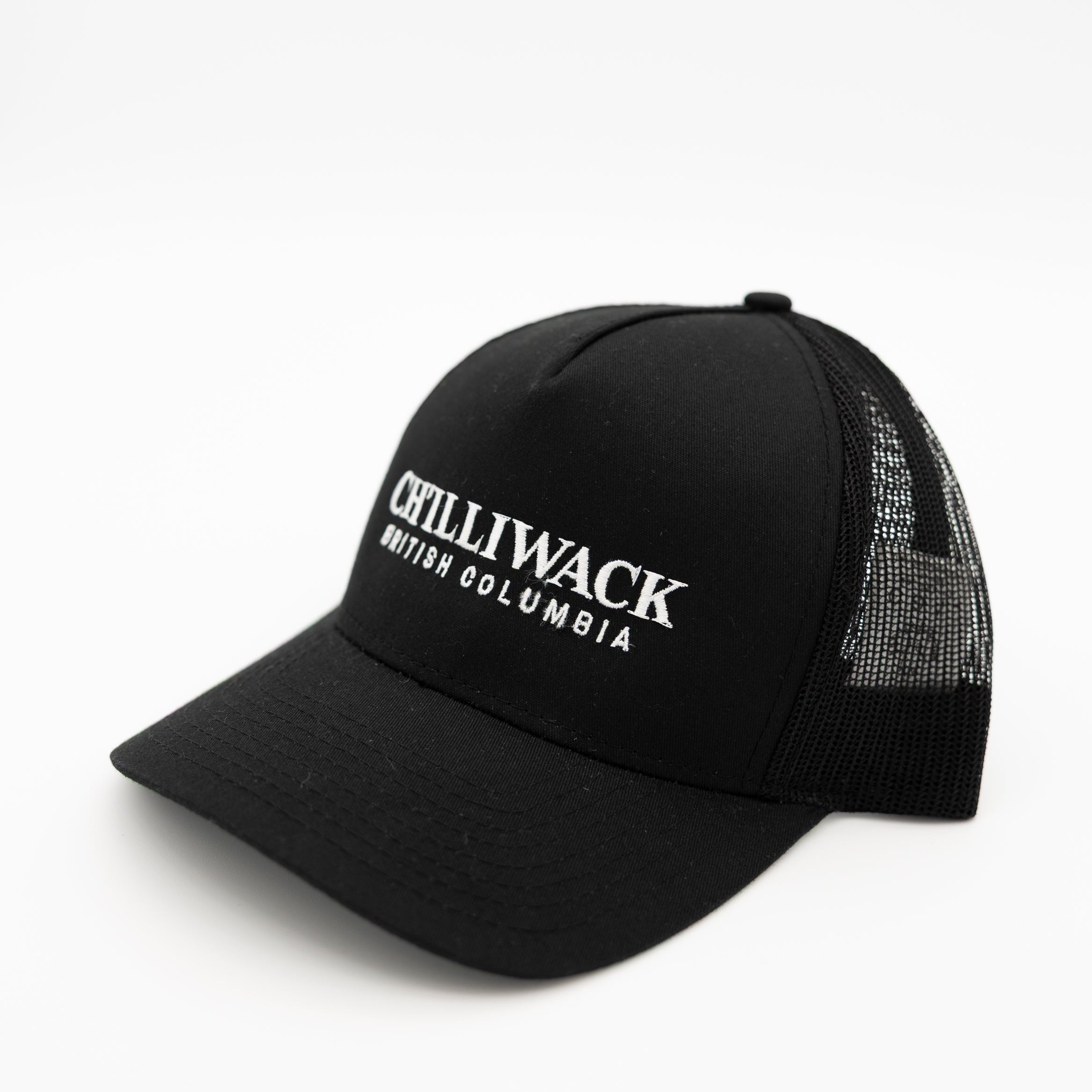 A black trucker-style baseball cap with white embroidered text reading 'CHILLIWACK BRITISH COLUMBIA' on the front panel, shown against a plain white background.