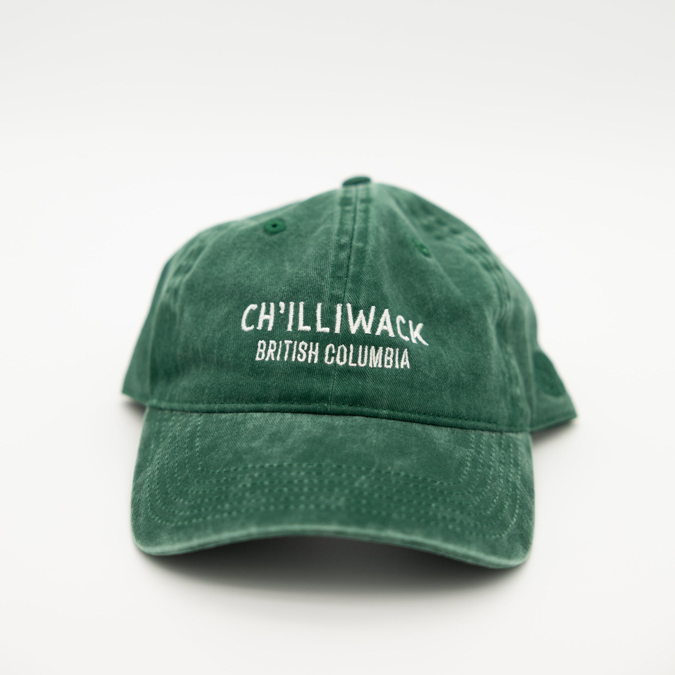 A green washed cotton baseball cap with white embroidered text reading 'CH'ILLIWACK BRITISH COLUMBIA' on the front, shown against a plain white background.