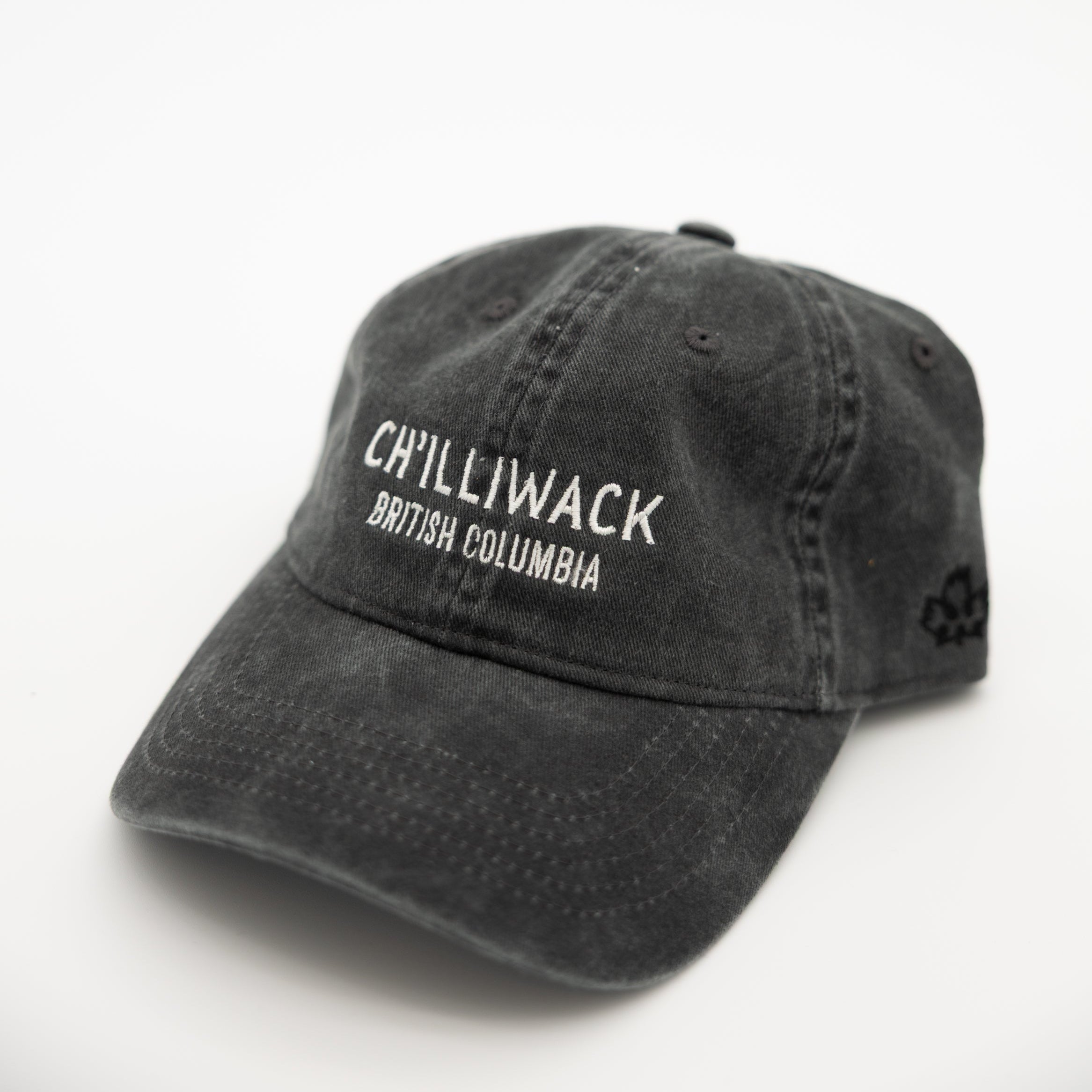 A washed black baseball cap with white embroidered text reading 'CHILLIWACK BRITISH COLUMBIA' on the front, photographed on a plain white background.