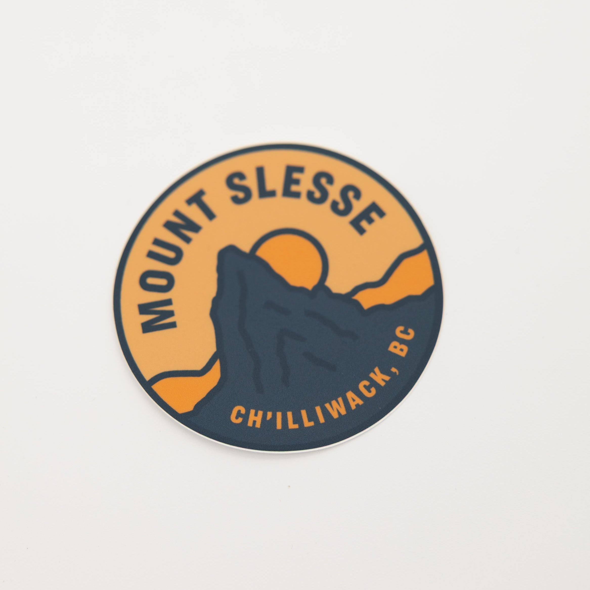 A circular sticker featuring a mountain graphic with the text 'MOUNT SLESSE' and 'CH'ILLIWACK, BC' on a plain white background.